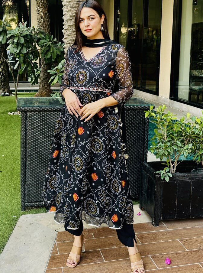 Upgrade your style with a Black Chiffon Bandhani Printed Anarkali Suit Set.