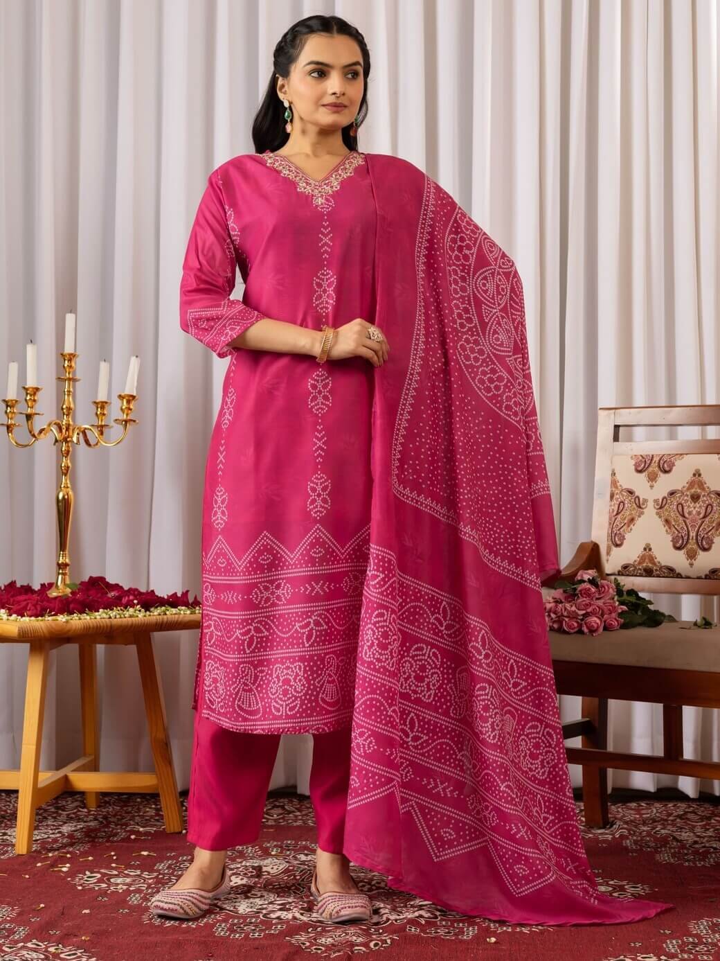 Improve your style with a Magenta Pink Muslin Silk Bandhani Printed Kurta, paired with matching pants and a dupatta.