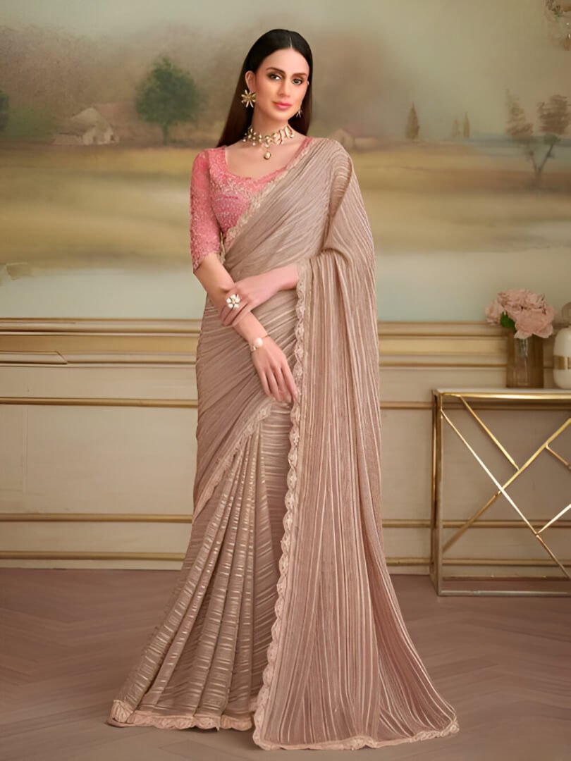 Step into style with a light brown georgette saree and a contrasting blouse.