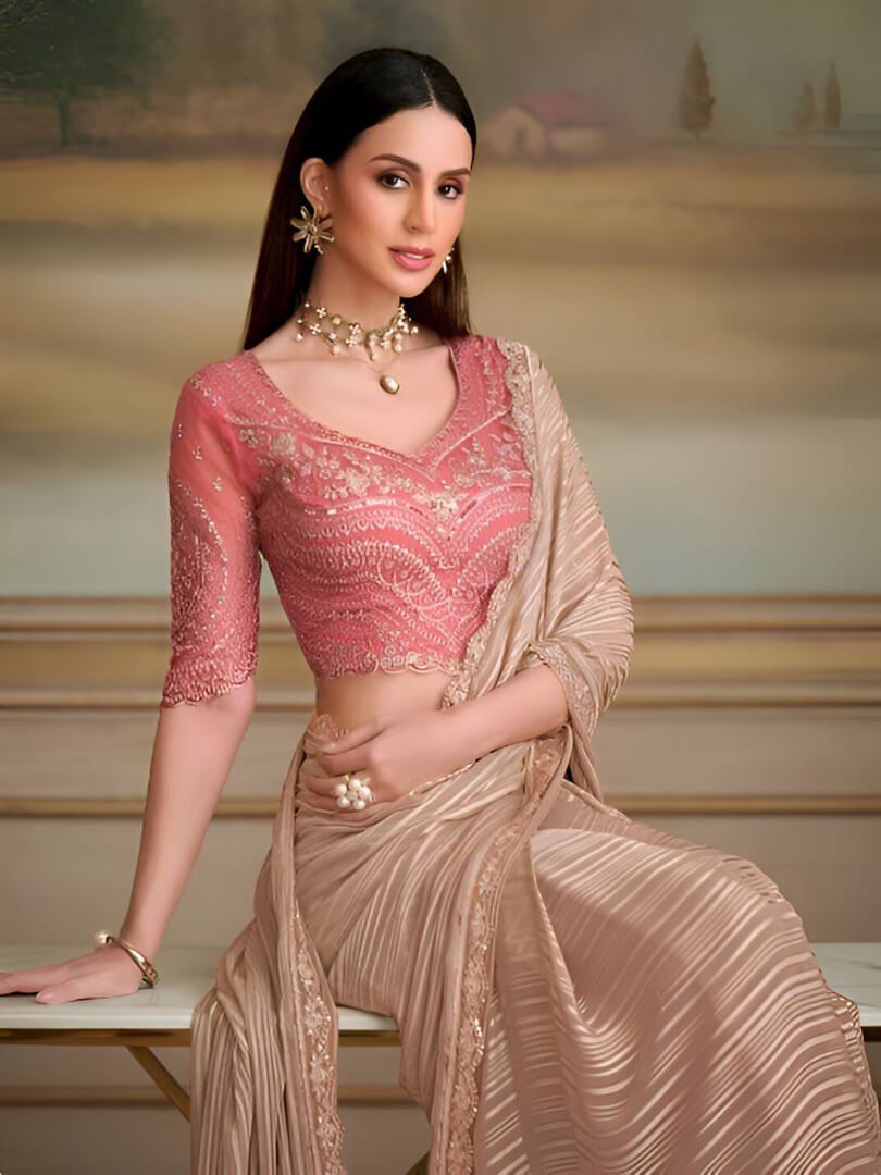 Step into style with a light brown georgette saree and a contrasting blouse. image 2