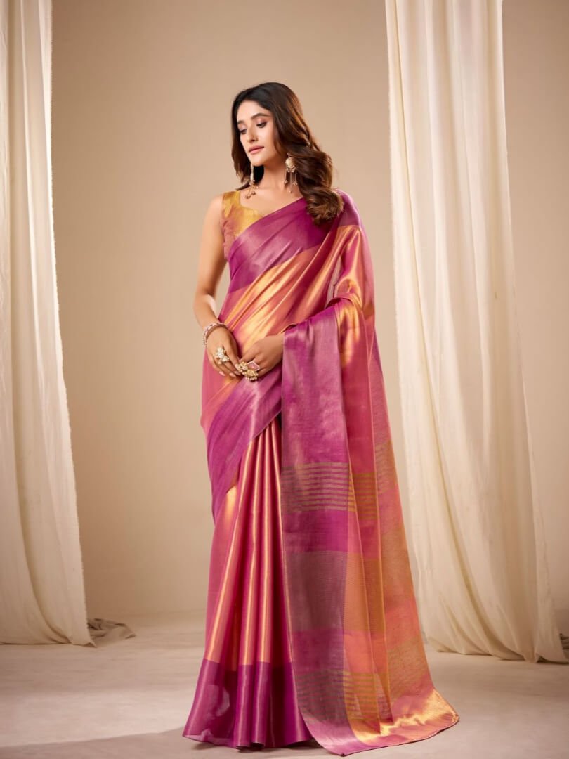 Look beautiful in a pastel pink and peach handloom tissue silk saree with a matching blouse piece.