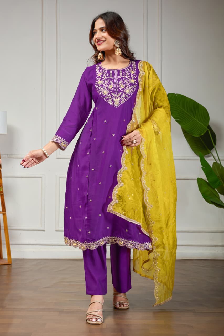 Upgrade your style with a Purple Roman Silk Anarkali Suit and a contrasting Organza Dupatta.