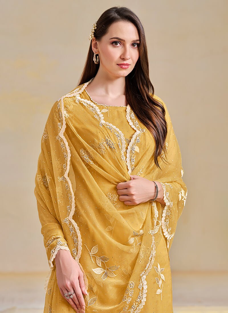 Add sparkle with a yellow semi-stitched salwar kameez set made of embroidered organza chiffon. image 2