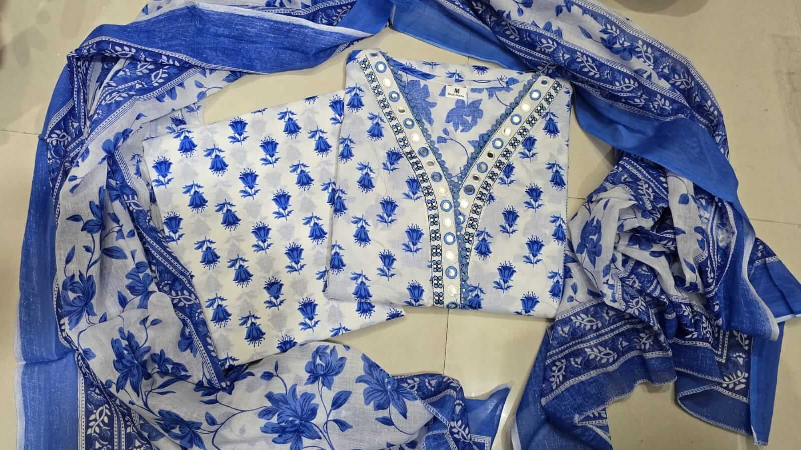 Enhance your look with a blue floral cotton short kurta, paired with matching pants and a dupatta. image 4