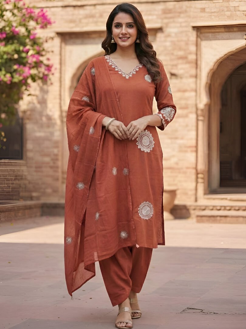 Experience elegance with the orange cotton kurta, pants, and dupatta set featuring beautiful embroidery.