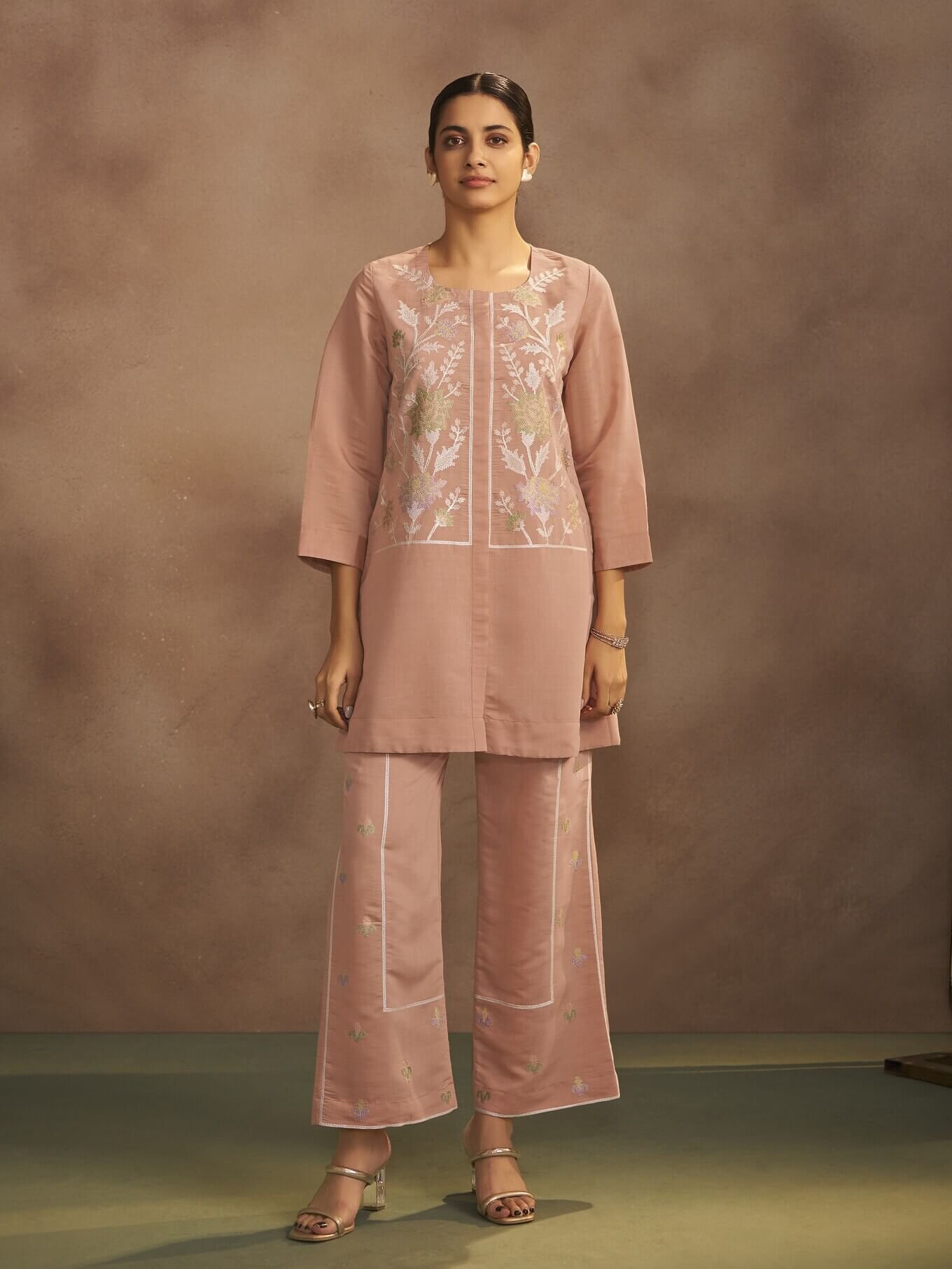 Improve your style with a peach-colored Roman silk co-ord set with embroidery.