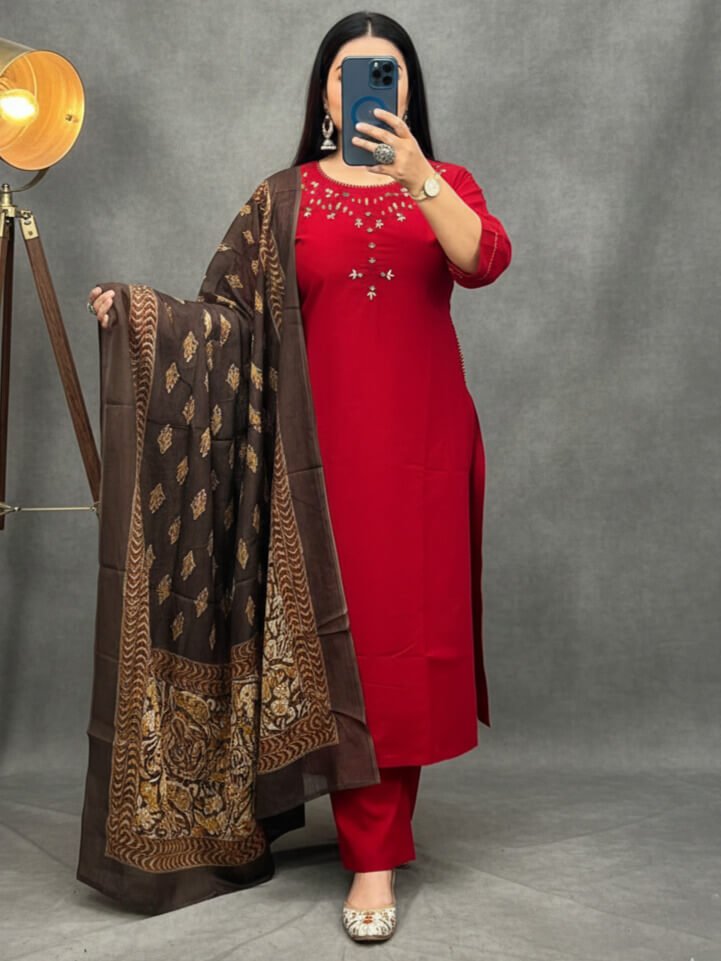Step into style with a red cotton kurti, matching pants, and a printed mulmul dupatta.