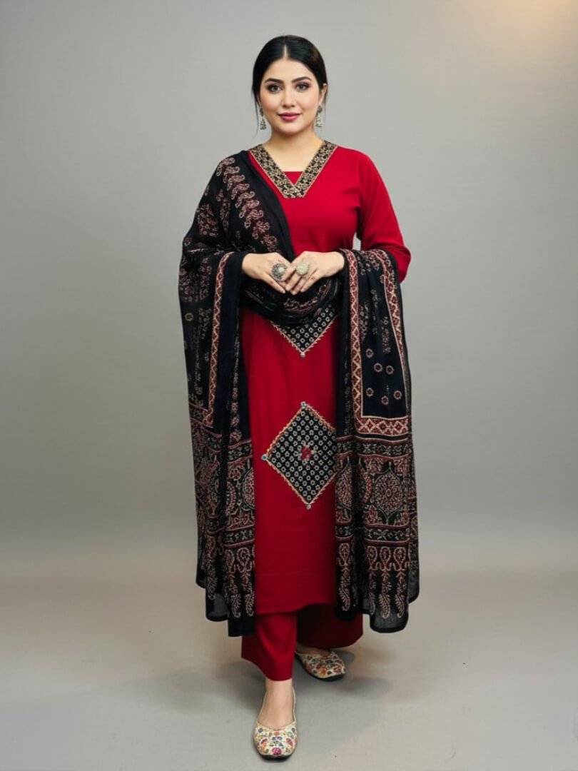Brighten your look with a red cotton kurti with mirror work, paired with pants and a black printed dupatta.