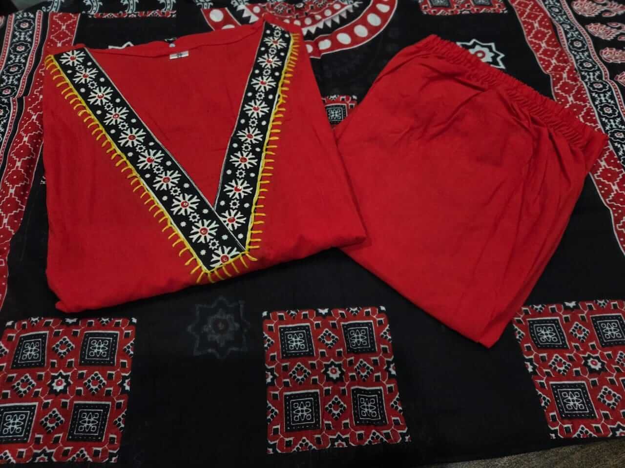 Brighten your look with a red cotton kurti with mirror work, paired with pants and a black printed dupatta. image 3