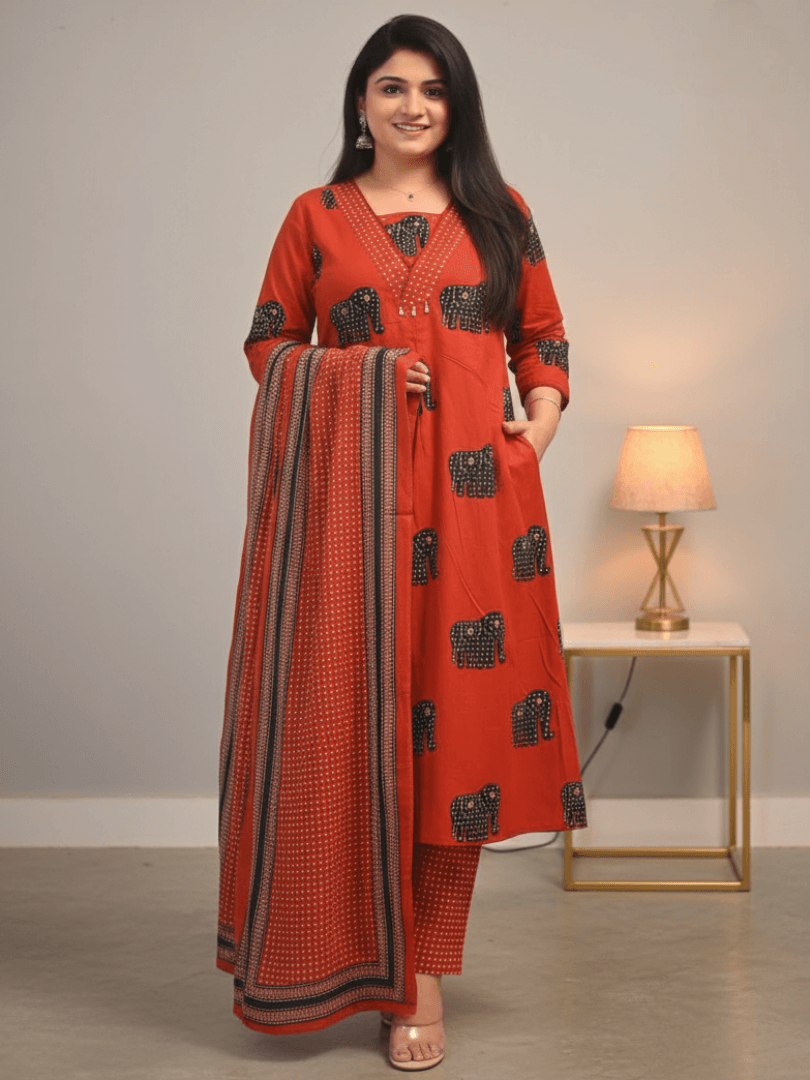 Step into style with a red animal print cotton kurta, pant, and dupatta set.